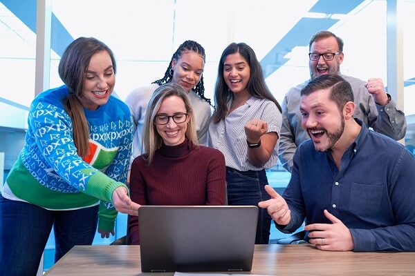 Several people looking at laptop